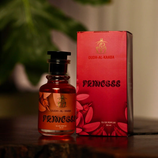Perfume bottle and packaging with 'Princess' branding on a wooden surface.